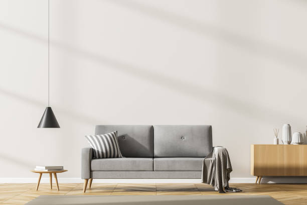 istock Living room interior with empty white copy space wall, grey sofa oak wooden parquet floor, coffee table, carpet. Concept of cozy meeting place. Mock up. 3d rendering 1325716954