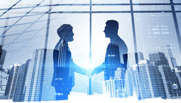 istock Business people handshake, skyscrapers and panoramic windows 1325718246