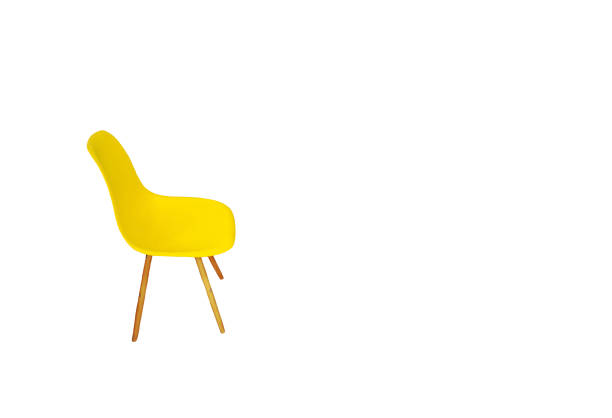 Yellow plastic chair isolated on white background, side view. Modern style empty seat for home kitchen cut out with copy space