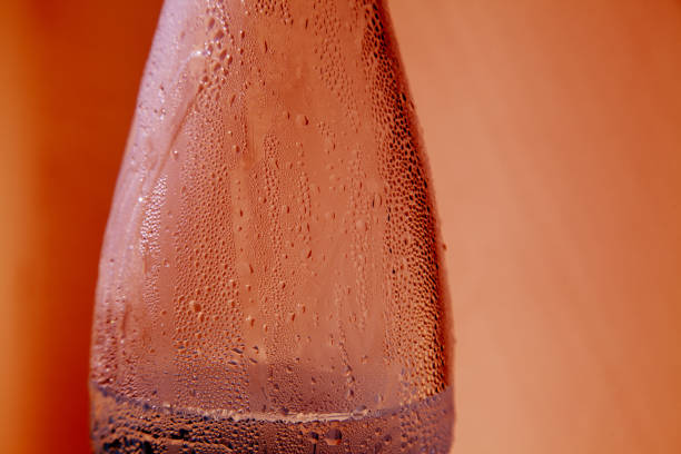 Stylized grungy red closeup of plastic bottle with condensation stock photo