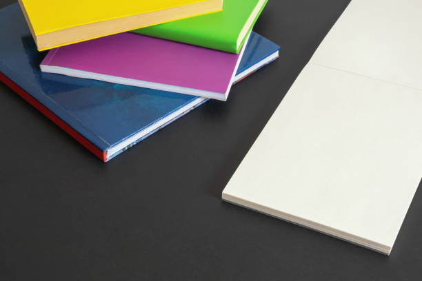 istock Colorful  books  and open sketchbook on dark table. Copy space 1325721708