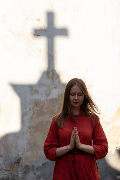 istock Young woman prays outside. 1325722144