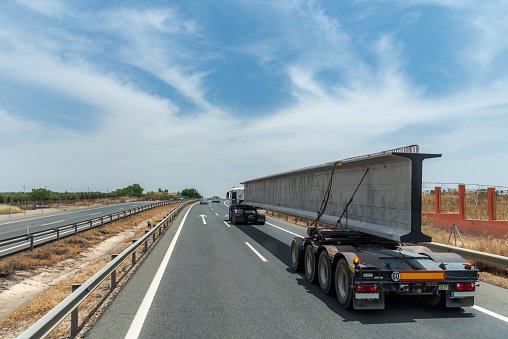 Special transport truck with a large beam used for highway bridges.