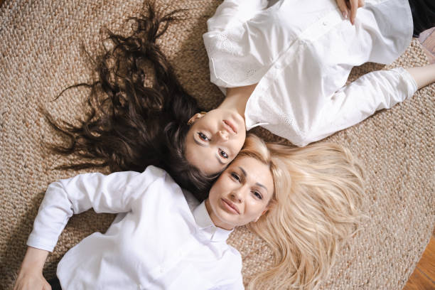 istock Mom and daughter lying on floor 1325723178