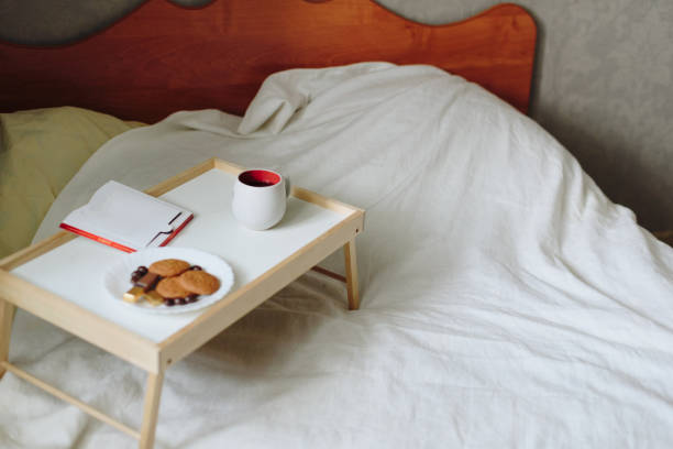 istock Breakfast and a book on the bed with a white sheet 1325724141