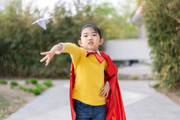 istock Superwoman Throwing a Paper Airplane 1325725882