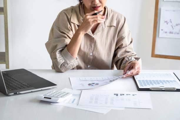 istock Professional at work, business woman working and analyzing on laptop with calculate statistics of financial document data graph for new project of business strategy and market growth at workplace 1325729009