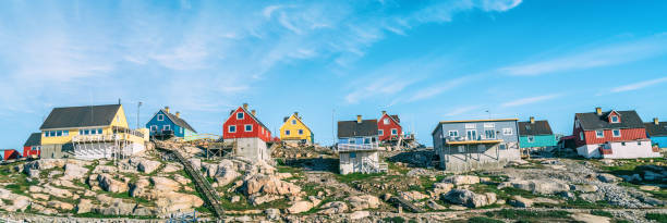 Greenland view of Ilulissat City and icefjord. Tourist destination in the actic Greenland view of houses in Ilulissat City and icefjord. Tourist destination in the arctic. Panoramic photo of typical Greenland village houses. ilulissat icefjord stock pictures, royalty-free photos & images