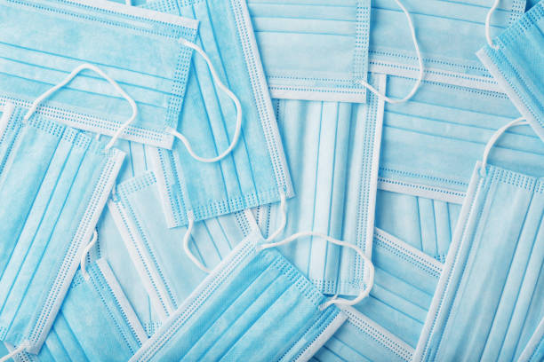 istock Protective medical masks are laid out as a background in full screen. 1325732578