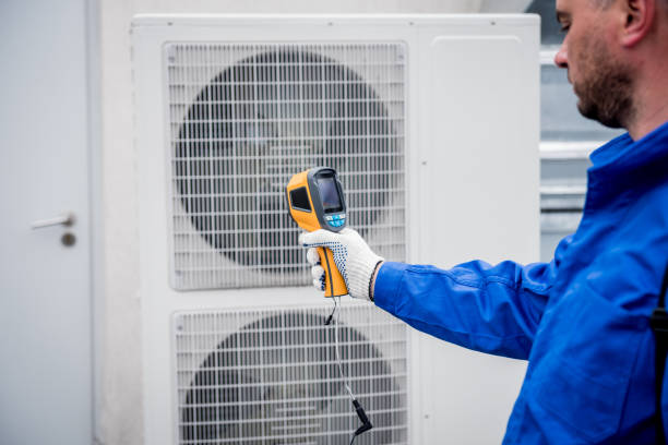 istock Technician uses a thermal imaging infrared thermometer to check the condensing unit heat exchanger. 1325733059