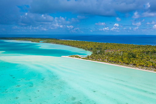 Drone photo of French Polynesia Tahiti Rangiroa Fakarava atoll and Blue Lagoon and motu island with perfect beach and coral reef. Aerial Tropical travel paradise in Tuamotus Islands.