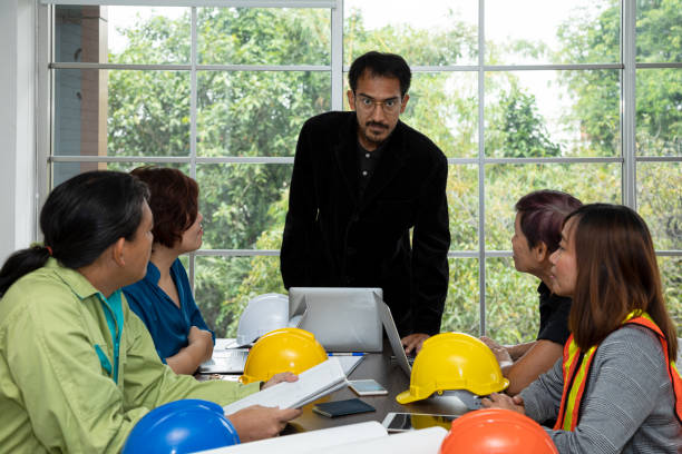 istock Group of construction team meeting. Asian young smart chief engineer standing looking at camera 1325735893
