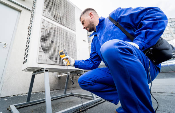 istock Technician uses a thermal imaging infrared thermometer to check the condensing unit heat exchanger. 1325735968