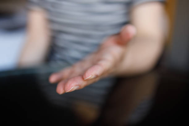 istock Woman’s hand held out over a desk 1325737153