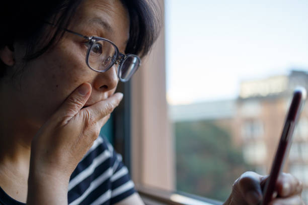 istock Woman reading her phone with shocked expression 1325737360