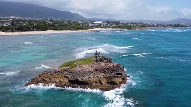 Aerial view Poseidon statue on a rock in the Atlantic ocean guarding the city Puerto Plata.