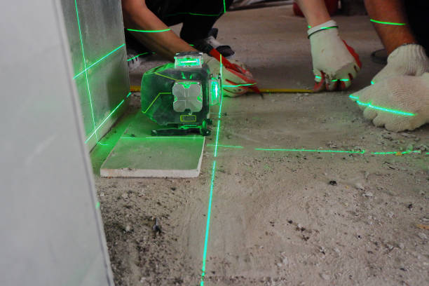 istock the builder measures the repair lines using a green laser level 1325739323