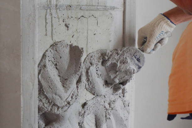 istock the builder-plasterer applies a plaster solution to the wall, construction works 1325739327