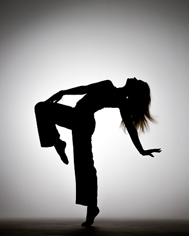 Rhythmic Gymnastics girl silhouette on gray background
