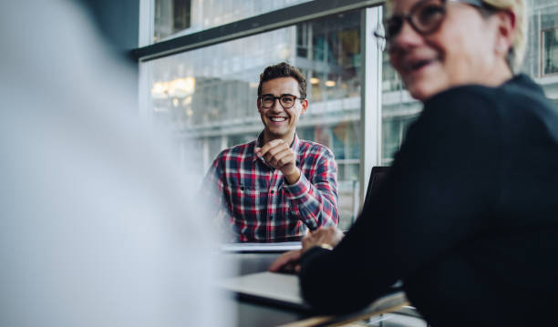 istock Happy businessman in team meeting 1325742010
