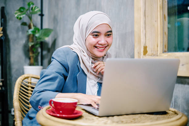 istock Young Hijab Woman Working From Cafe Using Laptop 1325742740