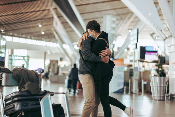 istock Woman hugging man after arrival from trip 1325743745
