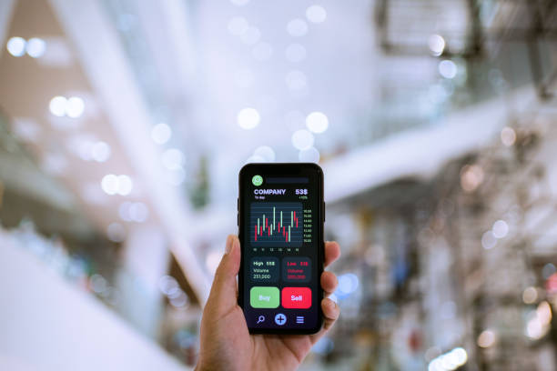 istock Businesswoman trader looking on smartphone with graphs analysis candle line. 1325745796