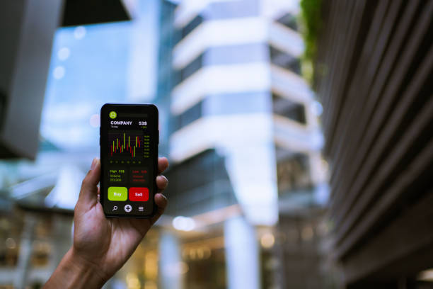 istock Businesswoman trader looking on smartphone with graphs analysis candle line. 1325745803