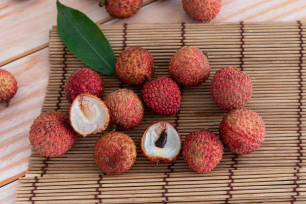 istock Fresh red chinese lychee fruit in bamboo basket on white background. 1325745832