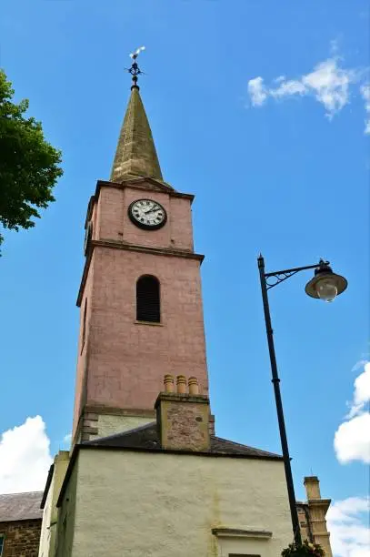 An exterior view of an old stone clock tower building in the Scottish borders village of Jedburgh.