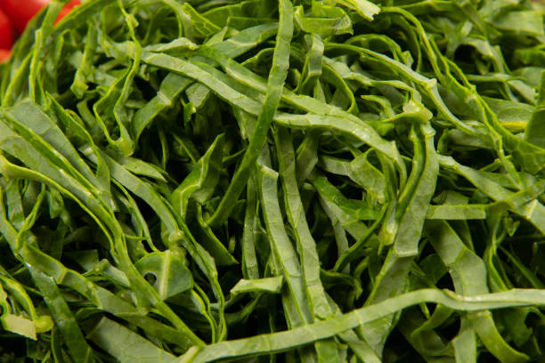 raw cabbage leaf cut and ready to sauté raw cabbage leaf cut and ready to saute on closeup view cabbage coral photos stock pictures, royalty-free photos & images