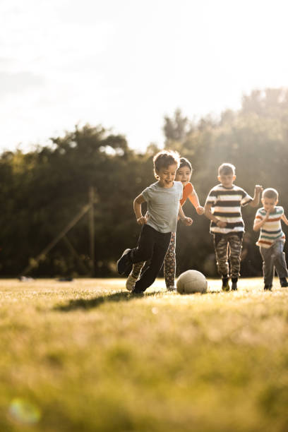 istock Children playing soccer on the meadow 1325747089