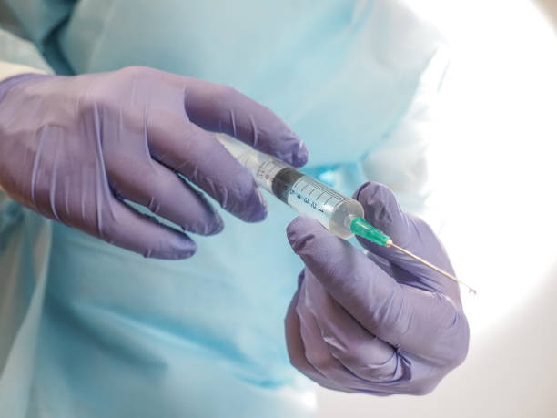 istock Doctor with a syringe 1325747419
