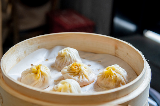 Xiaolongbao, traditional steamed dumplings and soy sauce. Xiao Long Bao buns on the cutting board. Top view.