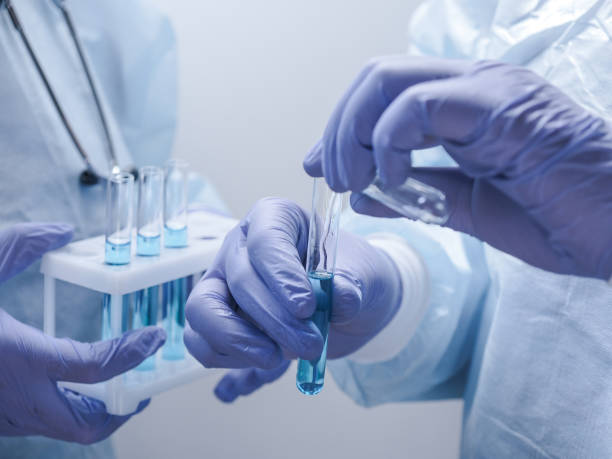 istock Two medical scientists hadling test tubes 1325748350
