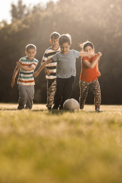istock Children playing soccer outdoors 1325749362