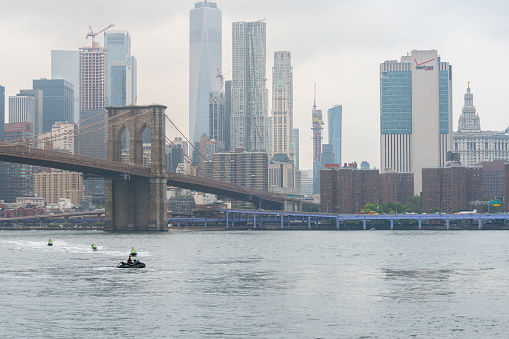New York City, USA - August 6, 2019:view of the famous brooklyn  bridge and New York skyline from Brookyn bridge park,during a foggy day.