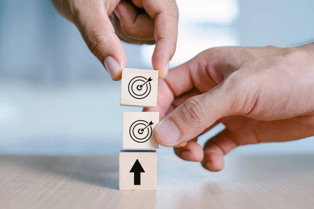 istock Business Hand putting virtual target board and arrow which print screen on the wooden cube. Business achievement goal and objective target concept. 1325756373