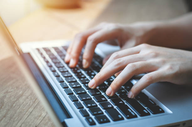 istock Close up of female hands while typing on a laptop keyboard. business or student using laptop at home, online learning, internet marketing, working from home, office workplace, freelance concept 1325757828
