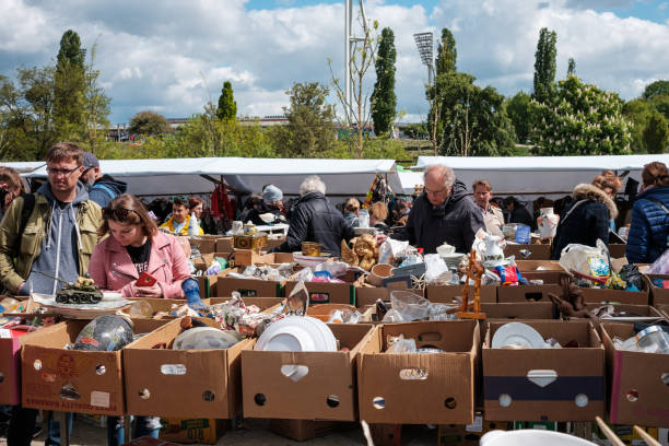 Berlin, Germany - May, 2019: People looking in boxes on flea market at Mauerpark  in Berlin