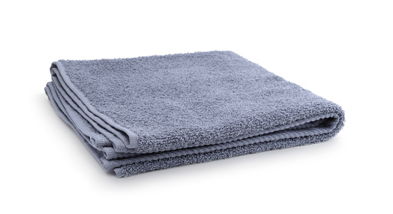 Folded gray terry towel isolated on white.