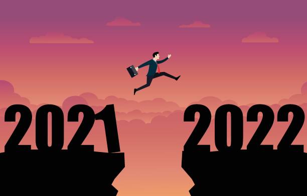 ein geschäftsmann springt ins neue jahr 2022 - silhouette landscape cliff mountain stock-grafiken, -clipart, -cartoons und -symbole