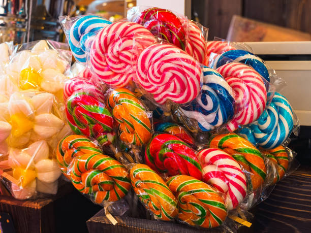 istock many multi-colored round lollipops in plastic packaging on the showcase of a candy store 1325763953