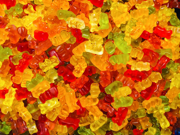 istock colorful teddy bear shaped sweet gummies - food background 1325763981