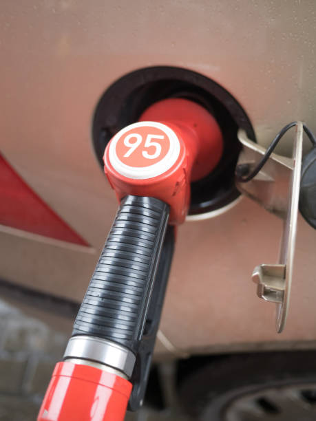 istock Fuel delivery gun nozzle inserted into the car tank 1325764585