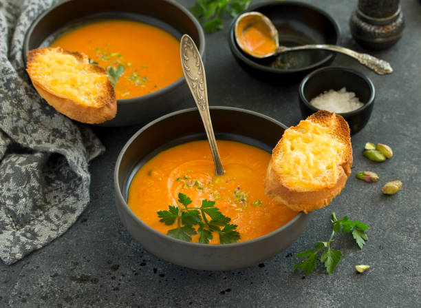 istock Pumpkin soup on a gray background. Selective focus. 1325765297
