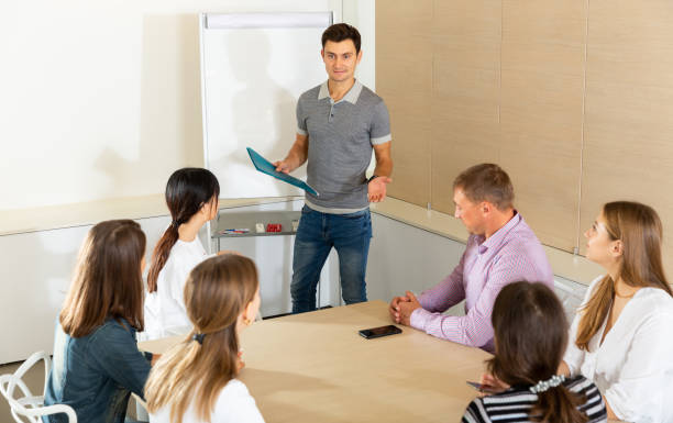 istock Young man sharing business ideas with colleagues 1325766351