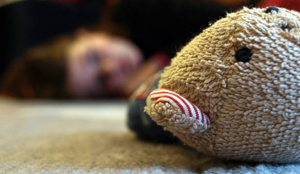 istock Stuffed bear in the foreground, child in the background 1325768972
