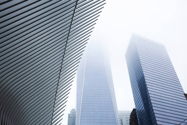 Skyscraper in Fog Modern glass skyscrapers in dense fog. skyscraper office building built structure new york city stock pictures, royalty-free photos & images