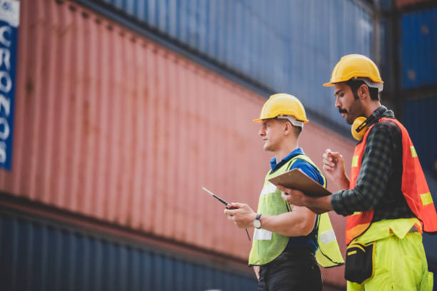 istock worker teamwork and partner of foreman, engineer, and businessman working in an international shipping area, concept of business industrial and working in container yard